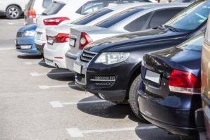 Cars lined up at a dealership. Aggregating activity across dealerships may increase your 199A deduction.