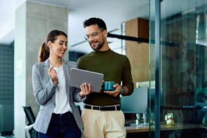 Businesswoman and her male coworker using touchpad in the office.Here are a few things to do to remain agile and resilient when it comes to nonprofit risk and financial resource planning.
