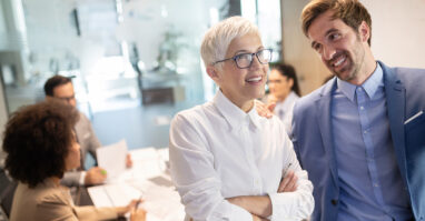 Older woman with team of advisors.web
