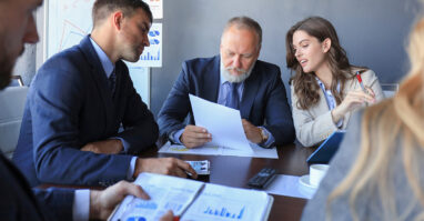 Business people reviewing KPIs.web
