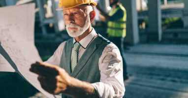 Businessman inspecting construction site.web