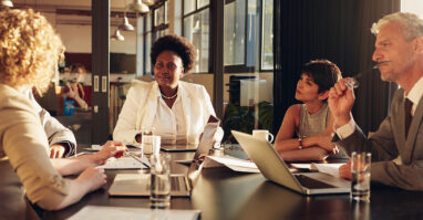 Management team around a table.web