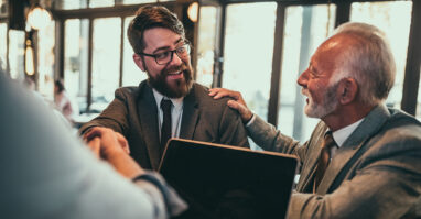 Father passing business to son.web